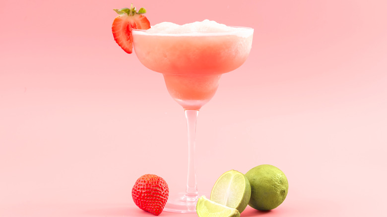 A frozen strawberry margarita with lime.