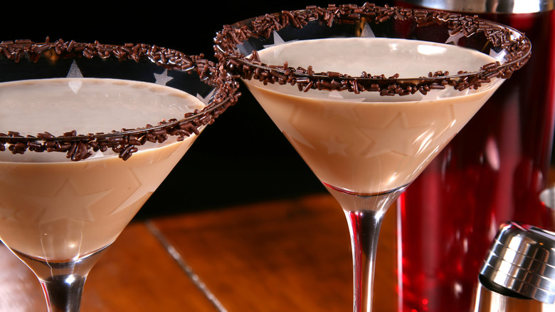 Two chocolatinis in martini glasses with sprinkle rims.