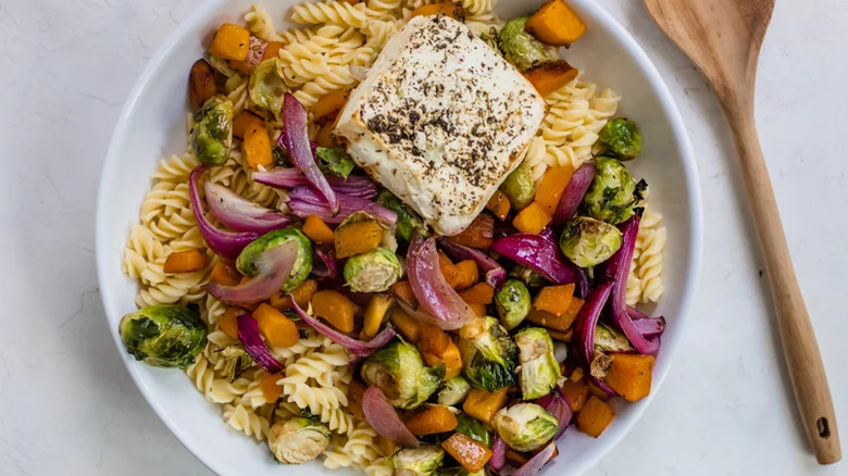 Feta, pasta, and vegetables in a plate