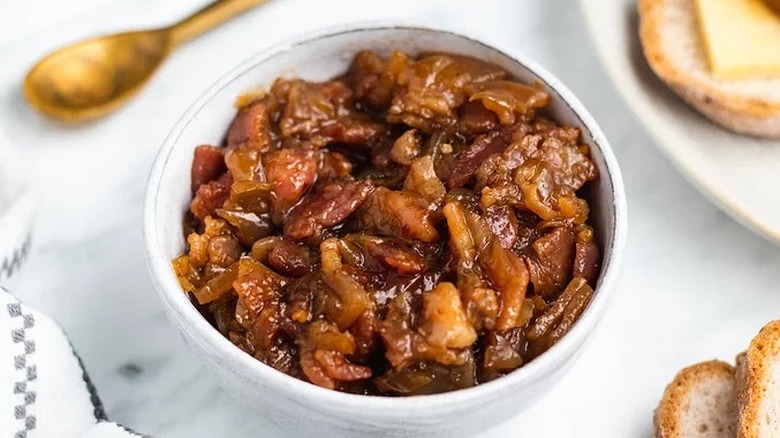 Bowl with cooked, chunky bacon jam.