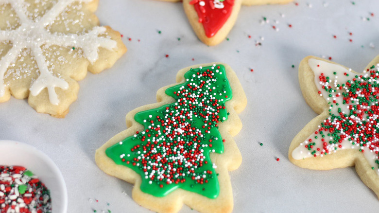 Sugar cookies in Christmas shapes with holiday decor.