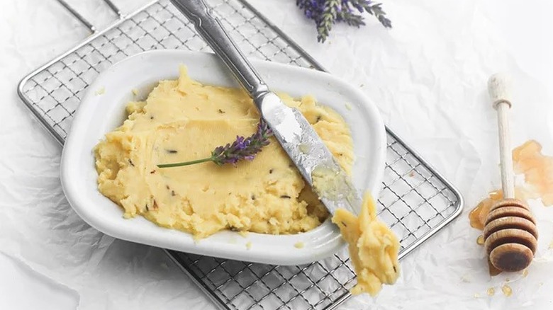 Homemade butter with honey and lavender sprig.