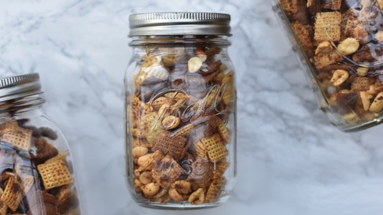 Mason jars full of Chex cereal snack mix.
