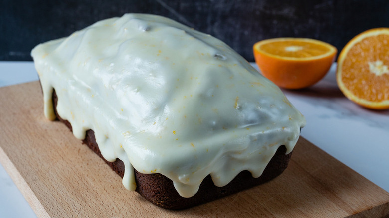 White frosting-covered chocolate quick bread. 