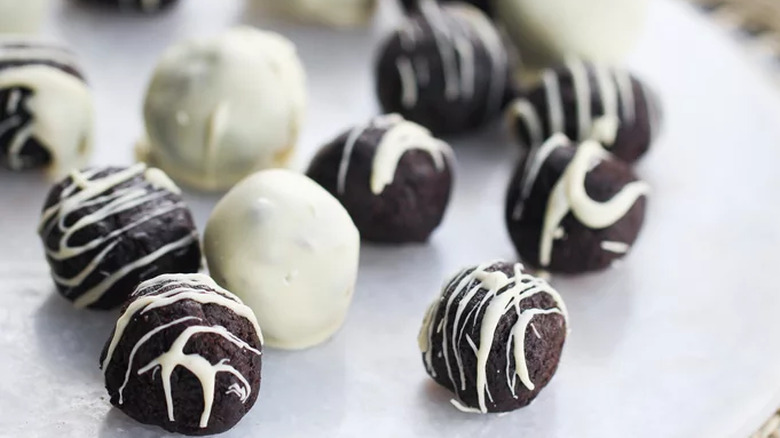 Dark chocolate truffles with white chocolate coating and stripes. 