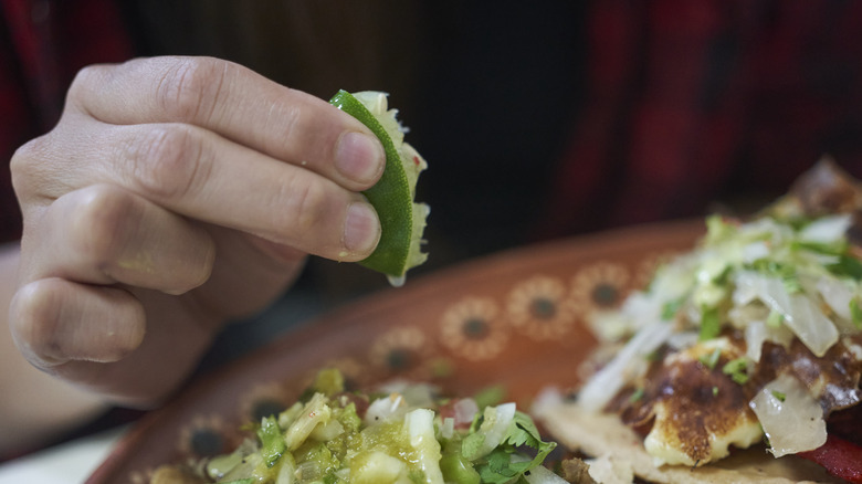 Lime being squeezed by hand