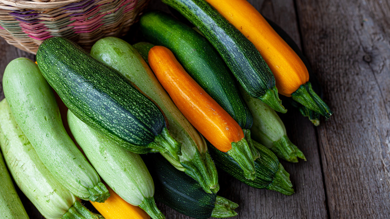 A set of multi-colored zucchini yellow, green, white, orange on the table close-up.