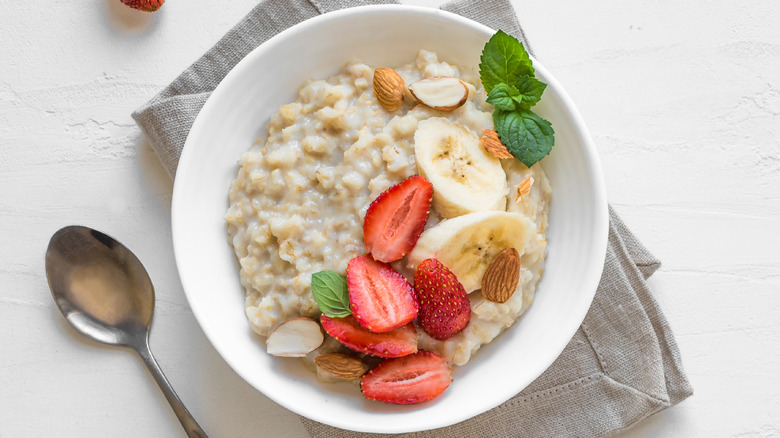 bowl of oatmeal with strawberries, bananas, and almonds