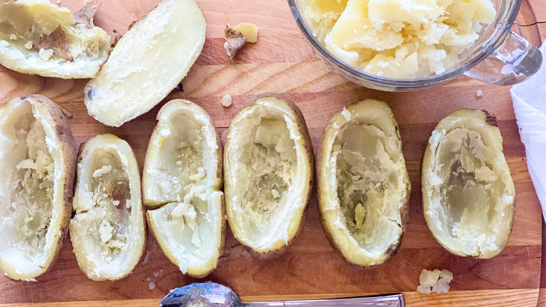 Scooping out the potato skins from Instant Pot twice-baked potatoes