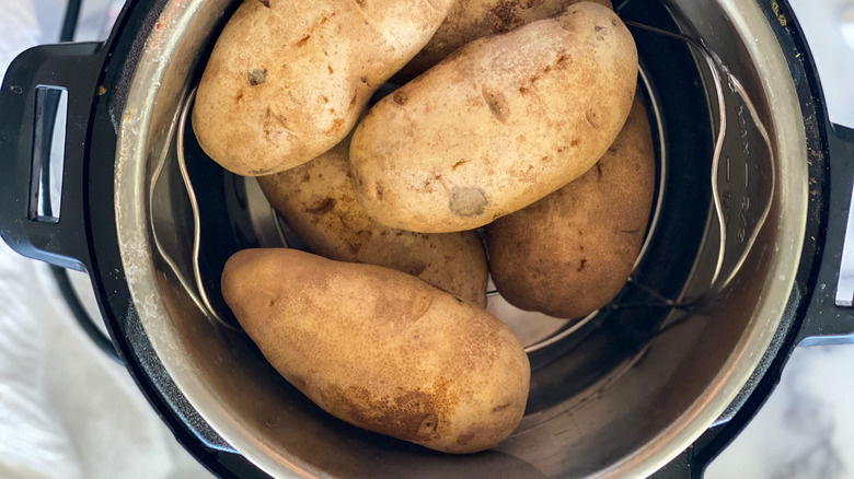 Potatoes stacked in an Instant Pot for Instant Pot twice-baked potatoes