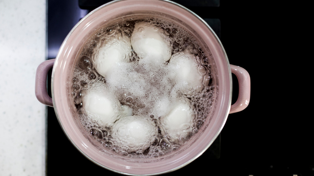 Eggs boiling in pot of water