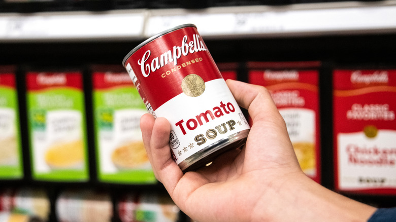 hand holding can of soup