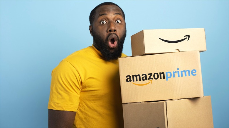 Surprised man holding Amazon boxes