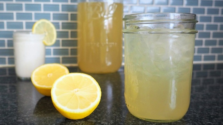 Lemon with mason jar of iced lemonade