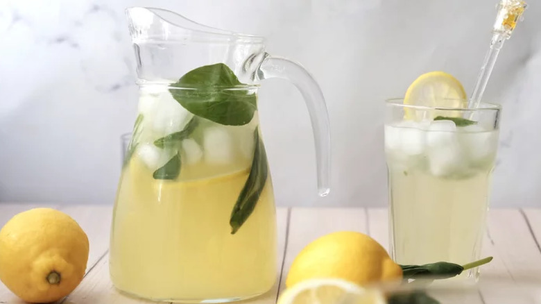 Glass pitcher with lemonade and ice