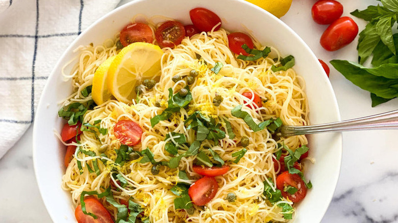 Large bowl of pasta with lemon and tomatoes