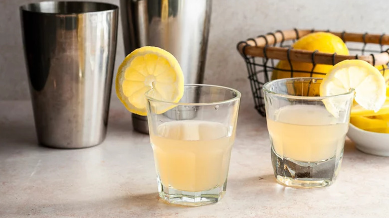 Drinks in shot glasses with lemon slices