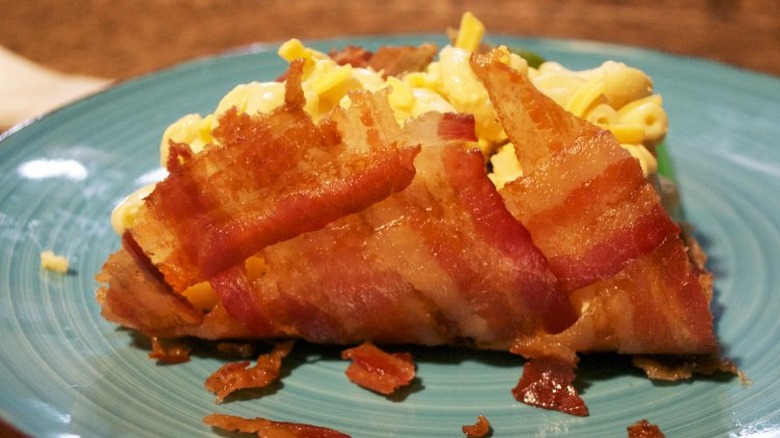 Shell made of bacon holding mac and cheese. 