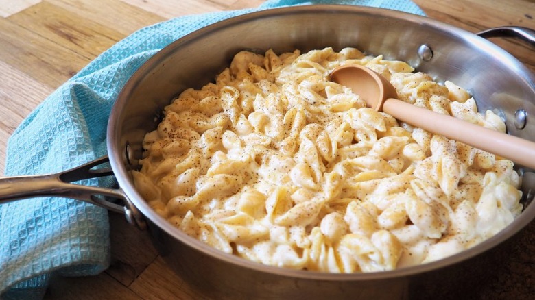 Large skillet with pasta in cheese sauce.