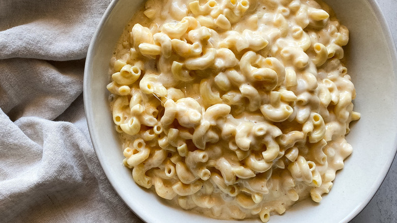 Elbow noodles in creamy cheese sauce in bowl.