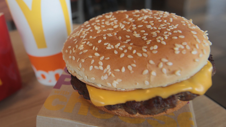 Quarter Pounder resting on container