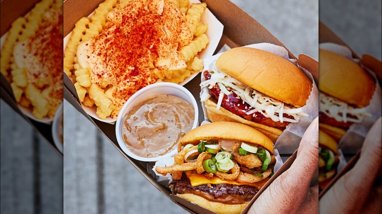 Box of Korean BBQ burger, chicken sandwich and fries