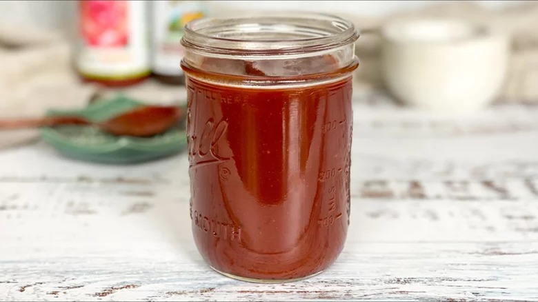 Barbecue sauce in mason jar on wood table