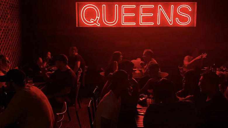 Neon Queens sign on bar patio