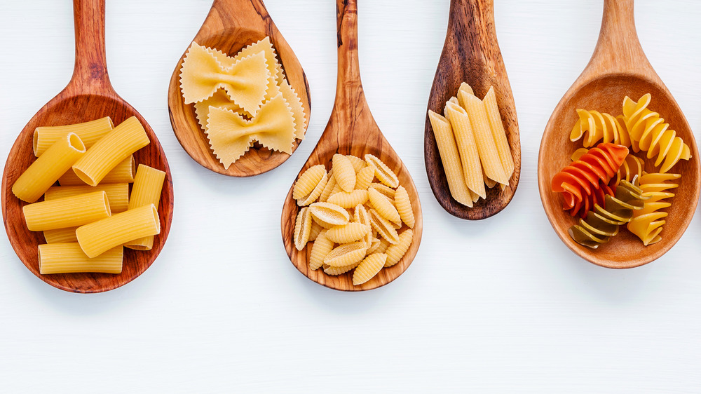 Pasta varieties on wooden spoons