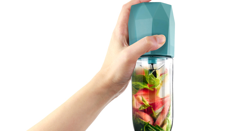 hand holding portable blender