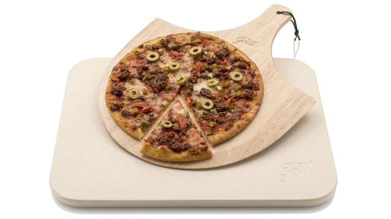 sausage pizza on wood pizza peel and stone