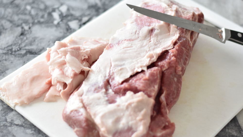 Pork butt being trimmed