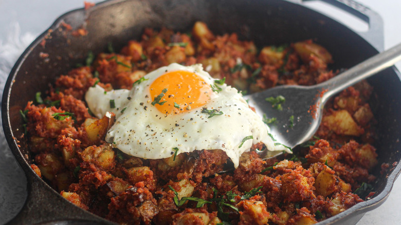 Cast iron pan of hash and fried egg