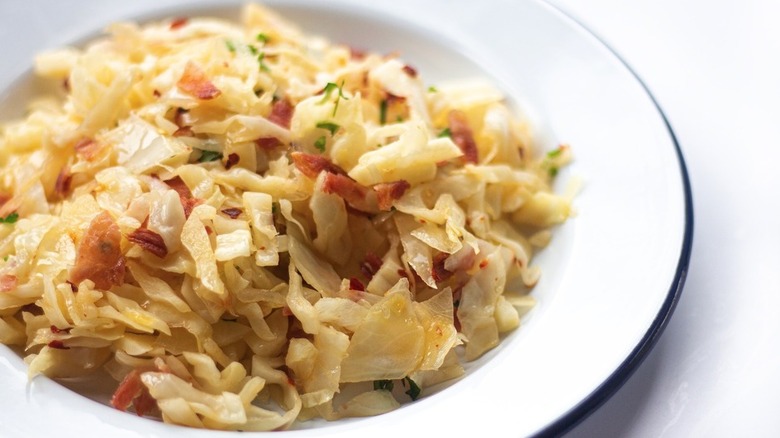 Bowl of fried cabbage with bacon bits