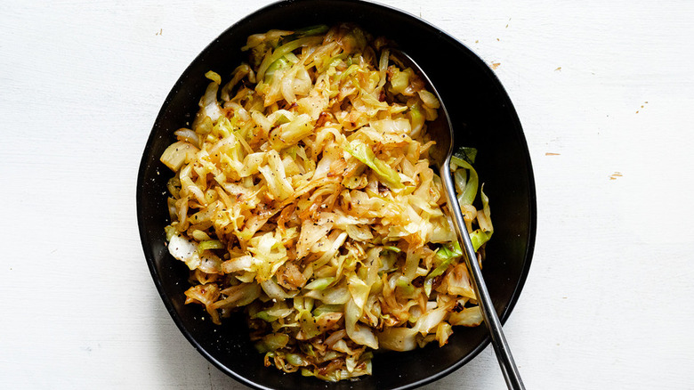 Black bowl of sautéed cabbage