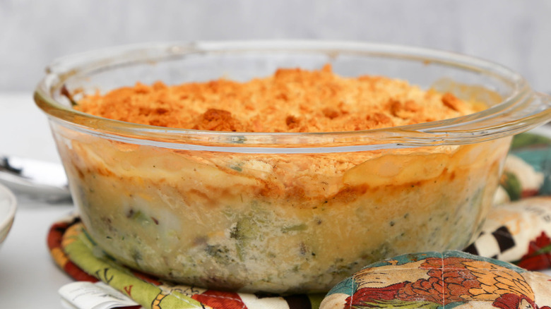 Glass baking dish with broccoli cheese casserole.