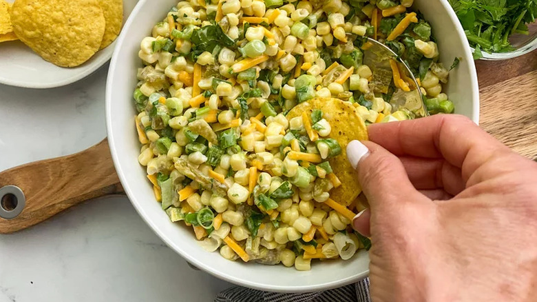 Bowl of corn, cheese, and scallion blended dip.