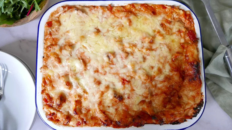 Pan of melted cheese-topped chicken casserole.