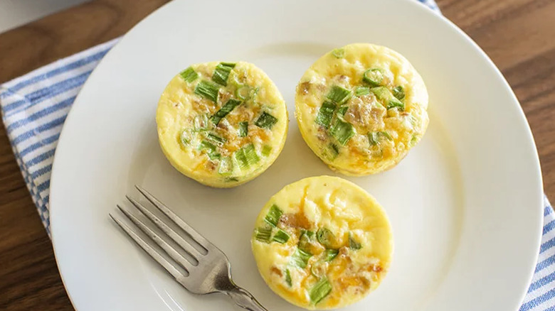 Three small baked egg bites with green onions.