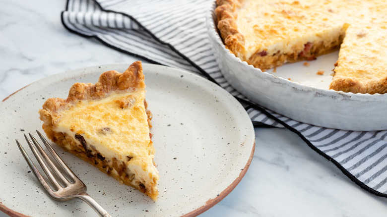 Round baked quiche with browned crust.