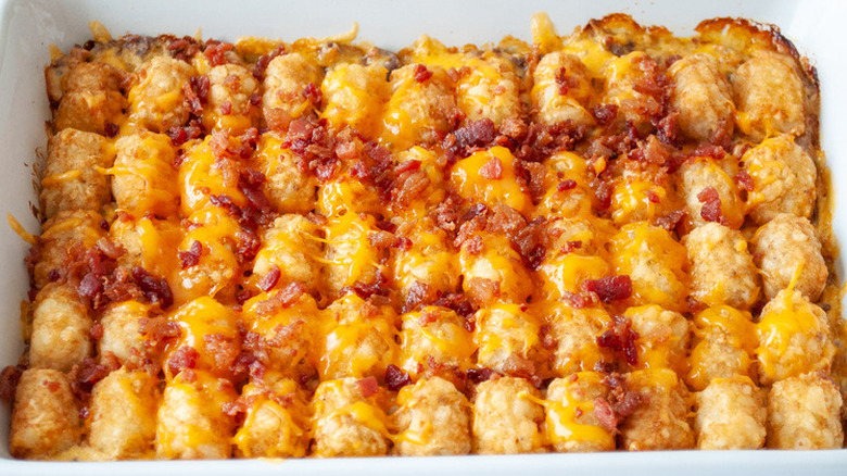 Casserole dish with baked tater tots and cheese.