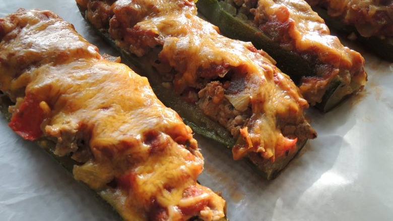 Planks of zucchini with meat and melted cheese.