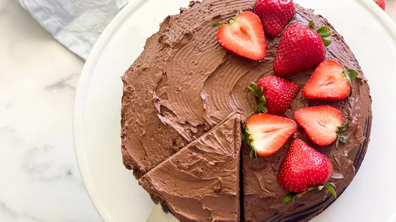 Round chocolate cake with slice cut