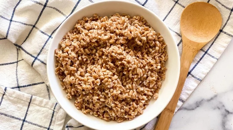 bowl of instant pot farro with wooden spoon