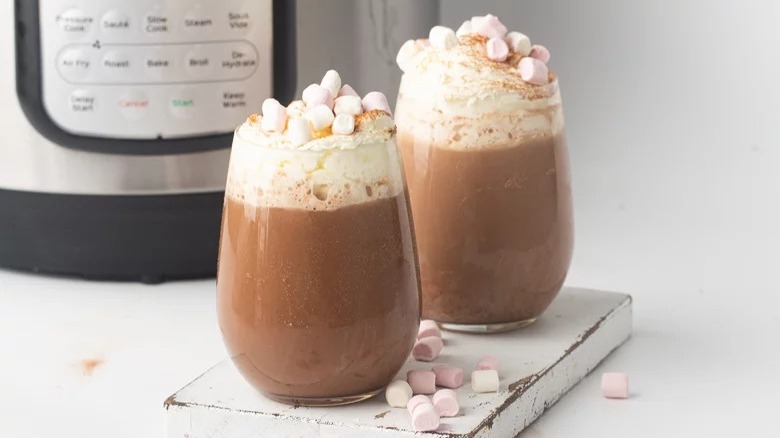 glasses of instant pot hot chocolate with whipped cream marshmallows