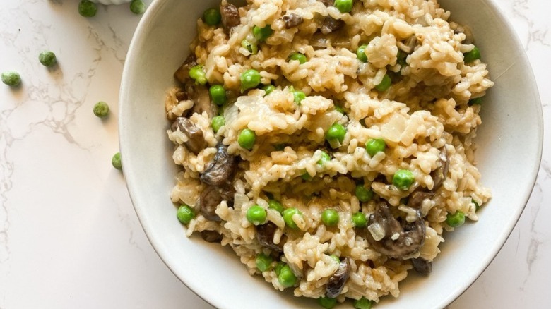 bowl of instant pot risotto with peas and mushrooms