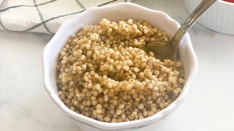 White bowl of cooked sorghum