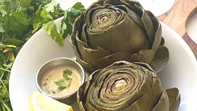 Steamed whole artichokes with sauce