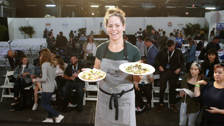 Chef Stephanie Izard holding plates