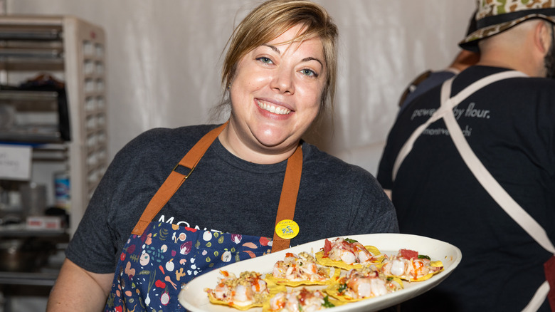 Chef Sarah Grueneberg holding plate of food